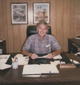 A young Phil Clegg sitting at a desk.